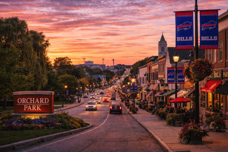 Sunset over Orchard Park's main street with local shops and Bills banners, Western New York